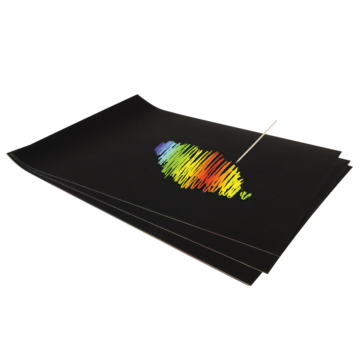 A stack of black-coated Scratch Rainbow Scraper Card sheets, the top sheet partly scratched to reveal a rainbow scribble in blue, green, yellow, orange and red. A pointed wooden scraper tool rests on the surface where the black coating has been scratched away.