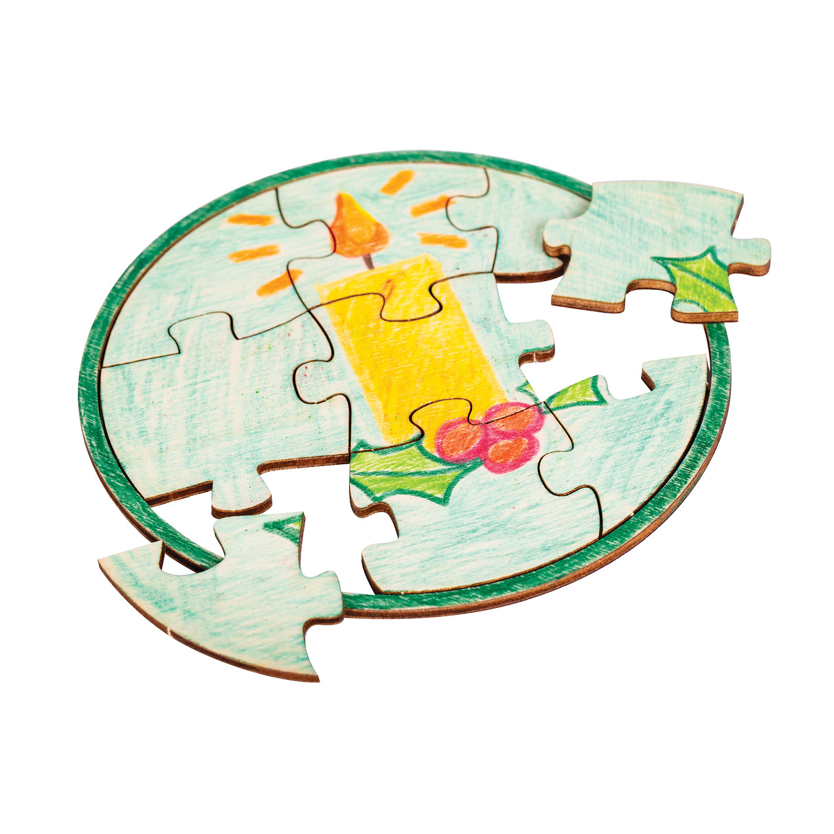 A round jigsaw sample made using a Zart Mini Jigsaw Round puzzle, hand-coloured with a festive candle design in yellow and orange, surrounded by holly leaves and berries in green and red, on a pale blue background with a green painted border. Two pieces sit detached.