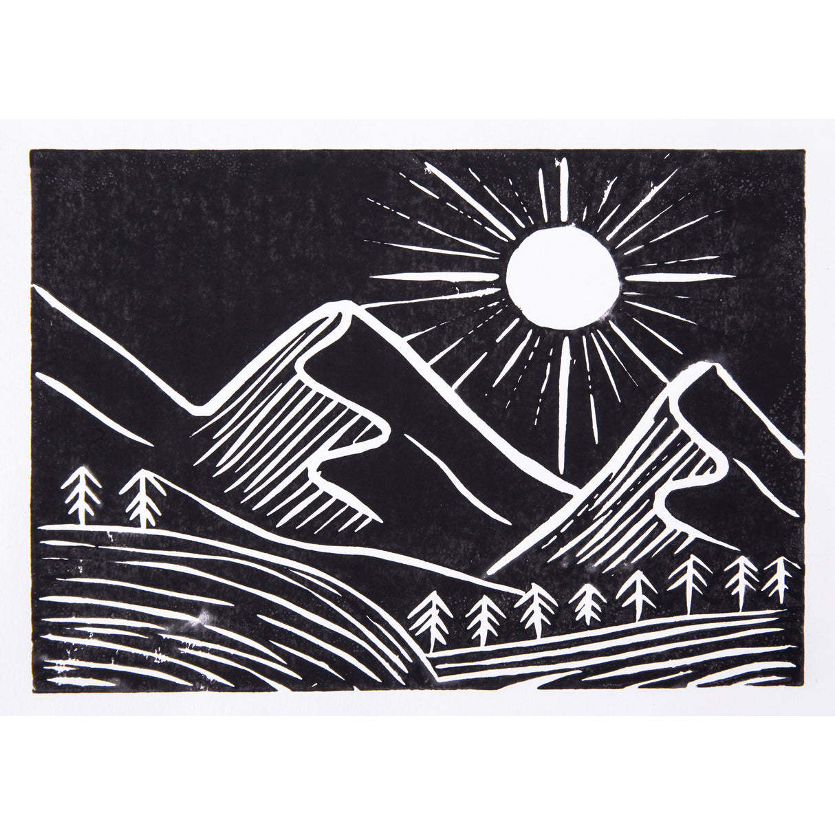 Black and white relief print of a mountain landscape featuring a large sun with radiating lines, layered mountain peaks and rows of small pine trees. Bold black areas contrast with white carved lines, creating strong tonal contrast and linear texture.