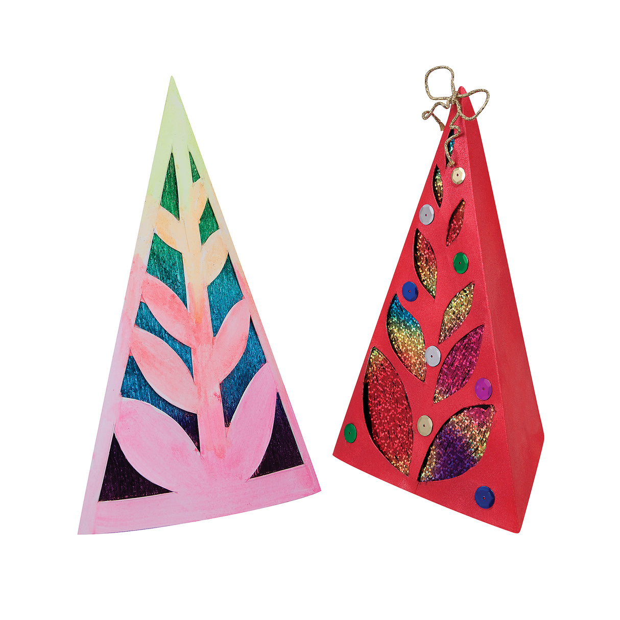 Two decorated 3D Zart Cardboard Trees. One is painted in soft pink and green with teal and purple showing through the cut-out leaves; the other is red with gold, pink and teal glitter panels, sequins scattered across the surface, and a gold wire loop at the top.