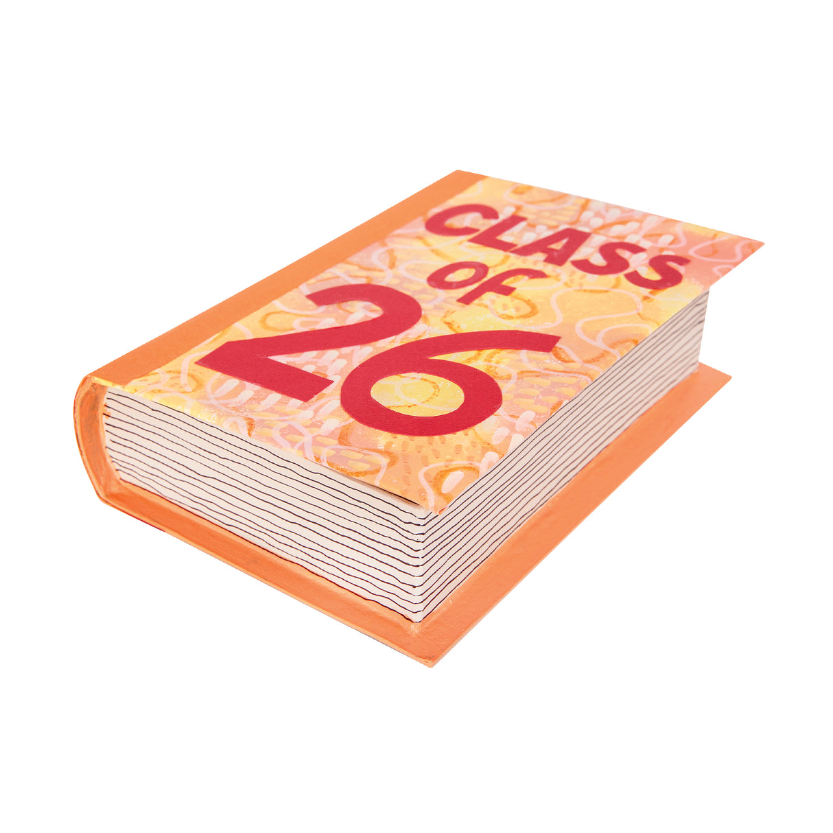A closed, painted orange Zart Papier-mache Book box designed to resemble a book, featuring a patterned cover reading "Class of 26" in bold red text over a swirling cream and yellow design. A striped, page-edge effect is painted along the closed side.