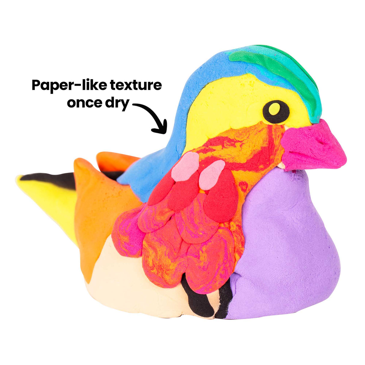 Vibrant three-dimensional bird sculpture crafted in bold candy colours including yellow, blue, pink, orange, purple and green, demonstrating Paper Magiclay's sculptural capabilities. Annotation reads "Paper-like texture once dry" with an arrow pointing to the smooth, layered surface finish of the artwork.