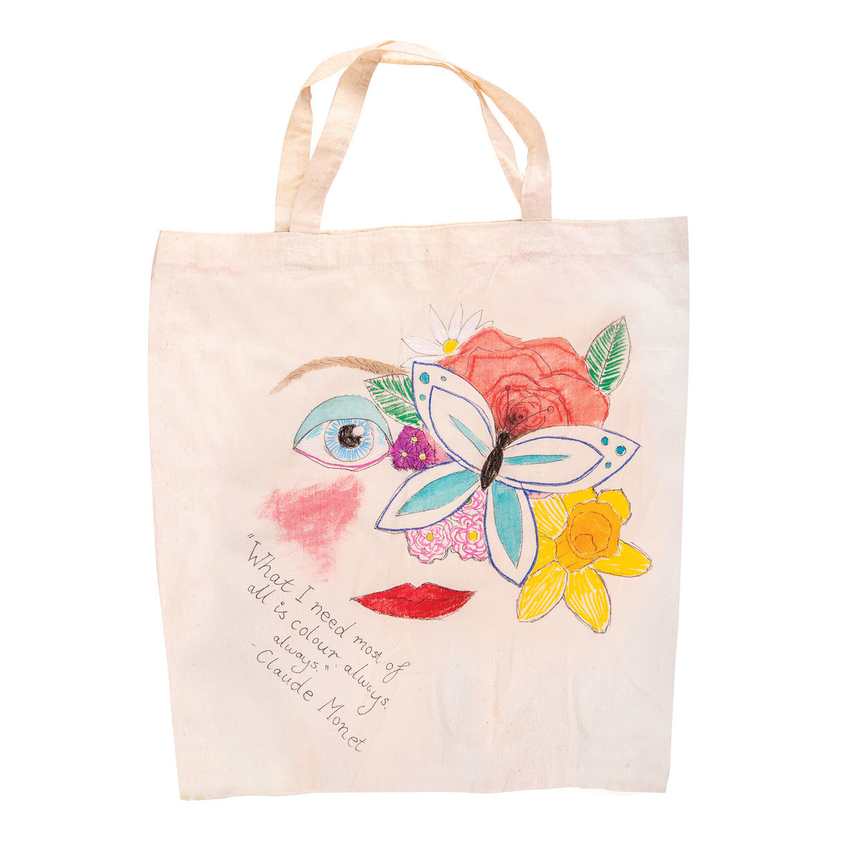 A Zart Calico Bag with Handles decorated as a sample artwork, hand-drawn and painted with an abstract face made from a butterfly nose, rose and daisy hair, a pink-lipped mouth and one eye, alongside the handwritten quote "What I need most of all is colour, always." – Claude Monet.