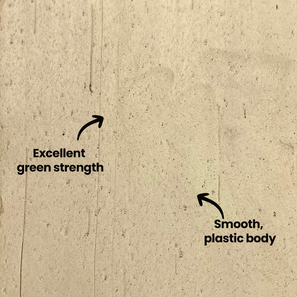 Close-up of beige stoneware clay surface showing natural texture with visible specks and grain. Two black arrows point to key features with annotations reading "Excellent green strength" and "Smooth, plastic body" highlighting the workable qualities of Northcote Stoneware Clay.