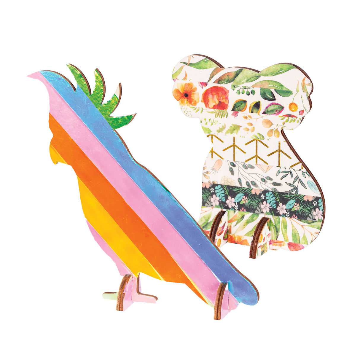Two wooden animal cut-outs, a cockatoo and a koala, decorated using Zart Washi Tape. The cockatoo is wrapped in rainbow foil stripes with a green crest, while the koala is covered in botanical floral and leaf-patterned tape with gold geometric accents.
