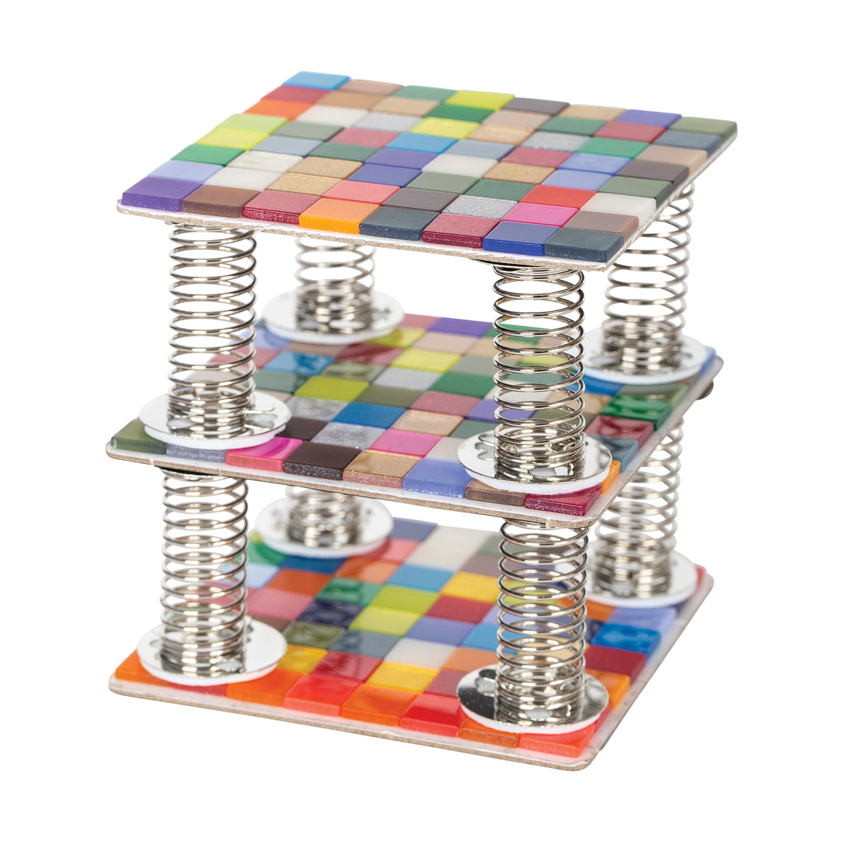 A layered sculpture of three square panels tiled with multicoloured Zart Deco tiles, stacked one above the other on coiled silver springs. Each panel carries a dense grid of glossy tiles in mixed colours — purples, greens, reds, blues and yellows — creating a bright, floating tiered effect.