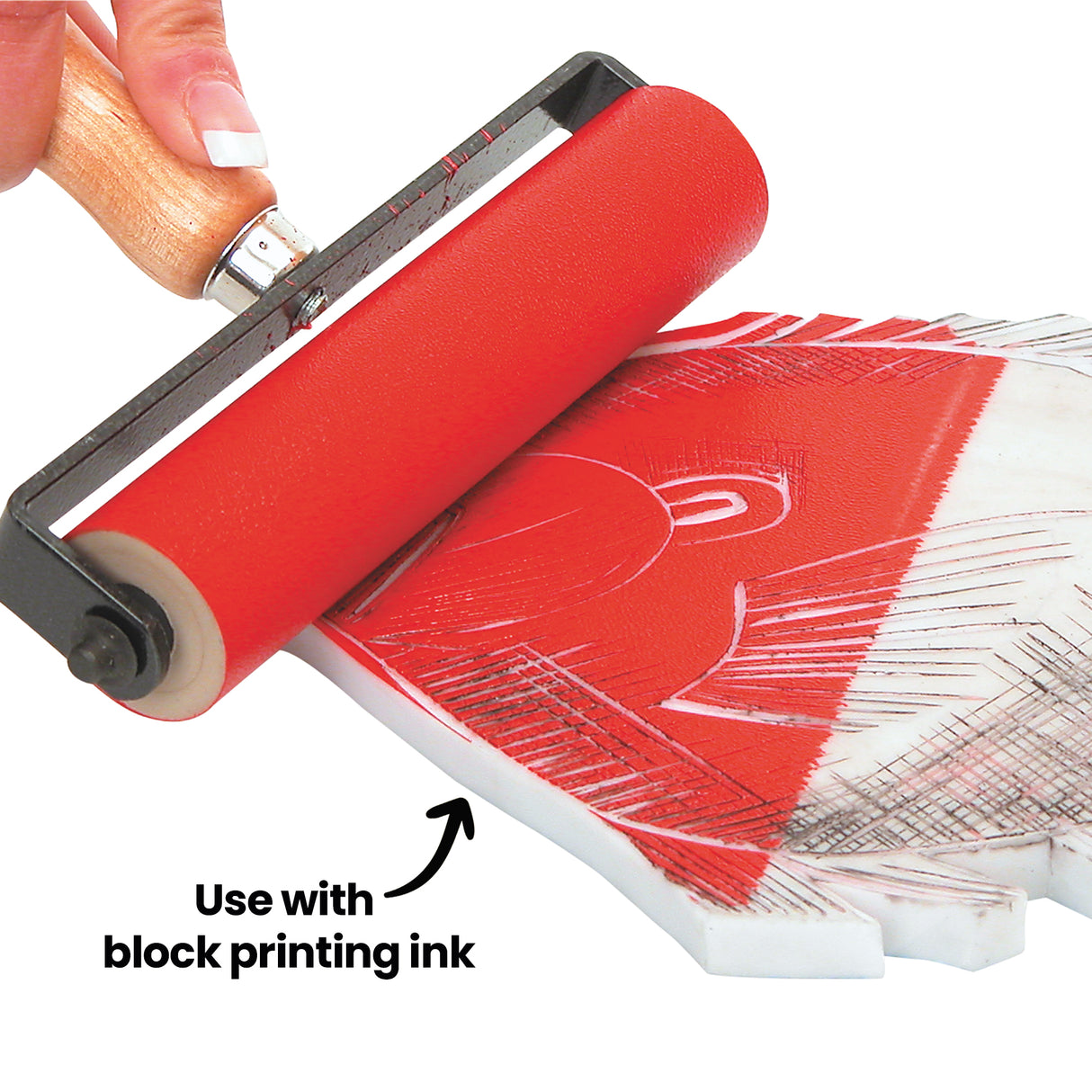 Close-up of a red inked roller applying block printing ink to a carved fish design on a white block. Black on-image text reads “Use with block printing ink” with an arrow pointing towards the inked surface.
