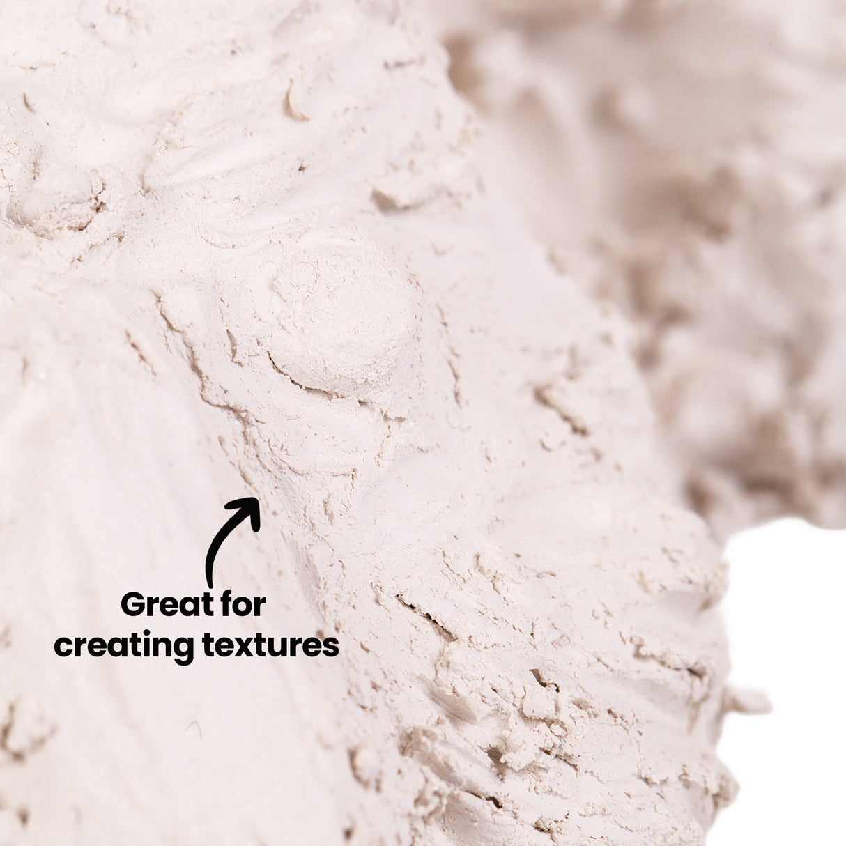 Close-up of pale grey-beige Zart Oz Clay showing its soft, malleable texture with visible grooves and impressions. The clay's surface demonstrates dimensional swirls and marks, with text reading "Great for creating textures" and an arrow pointing to the textured detail. The material appears smooth yet workable, ideal for sculpting projects.