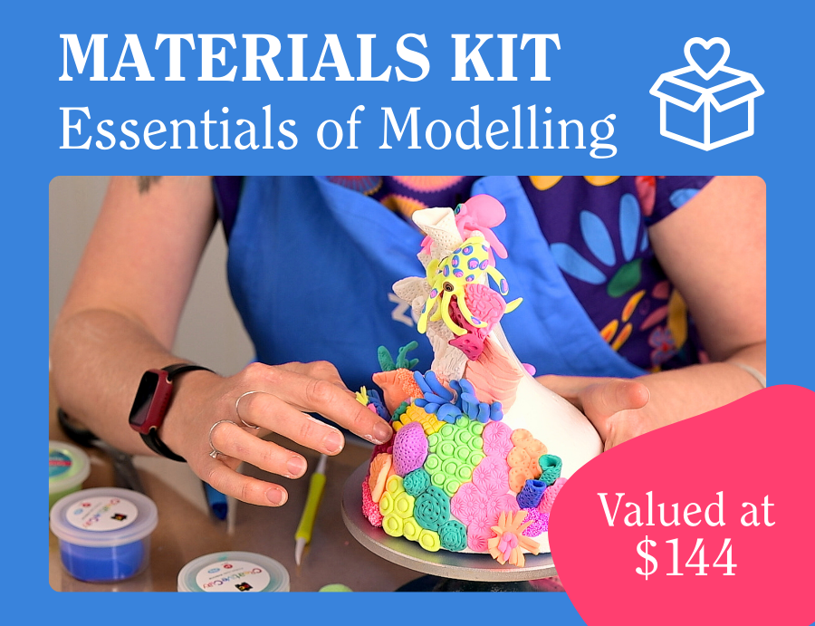 Promotional tile with a blue header reading “MATERIALS KIT” and “Essentials of Modelling”, with a white icon of a box with a heart above it. Below, a person wearing a blue Zart apron holds a colourful mixed-media sculptural form covered in bright textured pieces. A pink circle overlay reads “Valued at $144”. Credit: Zart Education PL The Essentials of Modelling.