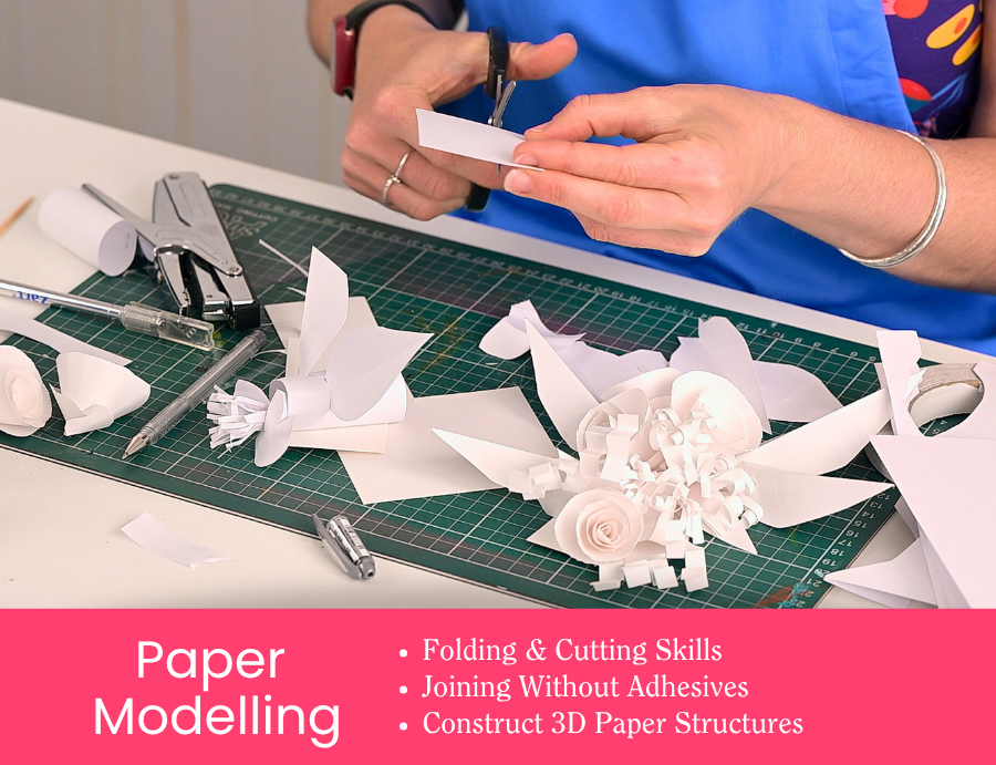 Zart Professional Learning Workshop value point tile for Essentials of Modelling: Paper Modelling. Hands cut and shape white paper into 3D sculptural flowers and birds on a green cutting mat, with scissors, a stapler, and craft tools alongside. Bullet points read: Folding & Cutting Skills; Joining Without Adhesives; Construct 3D Paper Structures.