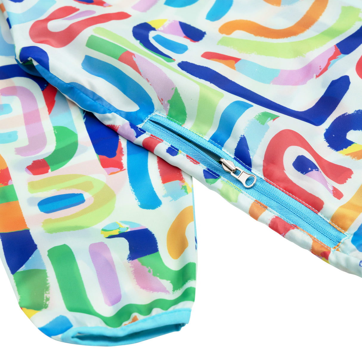 White art smock with vibrant abstract brushstroke pattern in blue, green, pink, coral, orange, and yellow. Features blue zipper closure and elasticated cuffs. The Spencil smock displays overlapping curved and straight painted strokes creating a colourful, artistic design perfect for protecting clothing during creative activities.