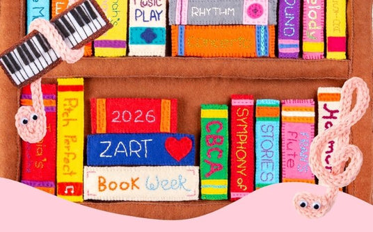 Promotional image for Zart Education Book Week Workshop Program 2026 showing stitched felt books on shelves, including 2026, ZART, Book Week, CBCA, Symphony of Stories and Stories. Two treble clefs with googly eyes and a felt keyboard decorate the scene.