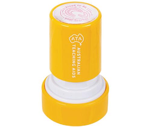 Bright yellow cylindrical Australian Teaching Aids stamp with white base and lid, featuring a pink fingerprint design on top. The stamp displays clear ridged details, perfect for creating textured prints in educational art activities and craft projects.