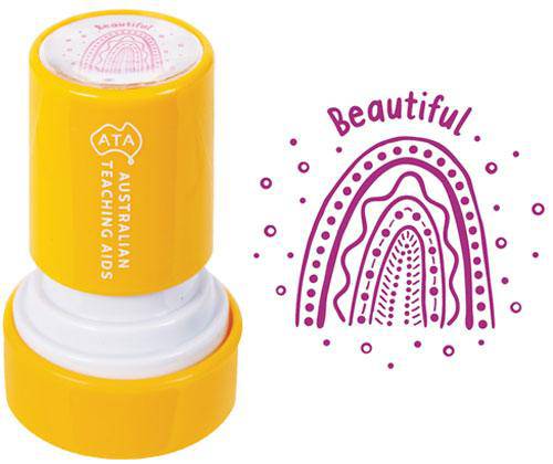 Yellow cylindrical Country Connections Stamps self-inking stamp shown from the side with white base, displaying the pink circular fingerprint design on top. Sample stamped impression on right shows decorative rainbow arch with dots and the word Beautiful in purple ink.
