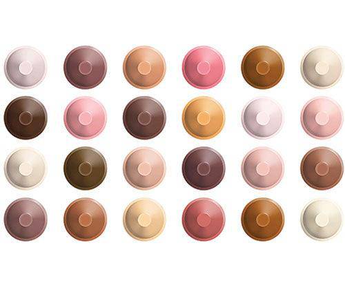 Twenty-four Crayola Colours of the World Crayons arranged in a grid, displaying a diverse palette of skin tone shades ranging from pale cream and peach to rich brown and deep mahogany. Each crayon is shown from above in its circular wrapper, featuring varied beige, pink, tan, and brown hues representing global human diversity.