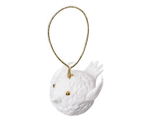 White textured clay sculpture of a round hedgehog with dimensional spiky details and golden bead eyes, suspended from a golden cord loop. The finished piece demonstrates Magiclay Porcelain clay's ability to hold fine textural detail and three-dimensional forms.