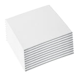 A stacked pile of small square white canvas boards is shown at an angle, revealing evenly layered edges. The surfaces display a fine woven cotton texture, with clean, crisp corners and a smooth, matte primed finish across each board.