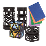 A collection of Zart Giant Lantern shapes in black card, showing different cut-out designs including a cylindrical lantern with criss-crossing strips, a hexagonal box lantern, and a decorated version painted with gold florals and coloured triangles. Beside them, loose sheets of blue, orange, green, and purple tissue paper.