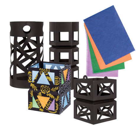 A collection of Zart Giant Lantern shapes in black card, showing different cut-out designs including a cylindrical lantern with criss-crossing strips, a hexagonal box lantern, and a decorated version painted with gold florals and coloured triangles. Beside them, loose sheets of blue, orange, green, and purple tissue paper.