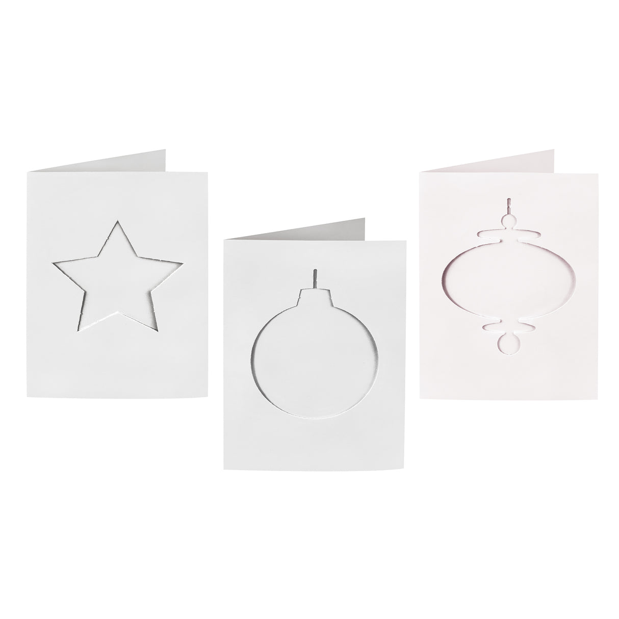 Three plain white Zart Cards and Envelopes Xmas Cut-Outs cards, each three-fold and featuring a different die-cut window shape — a star, a round bauble and a slim finial bauble. The blank cut-out frames sit ready for backing paper or colour to show through.