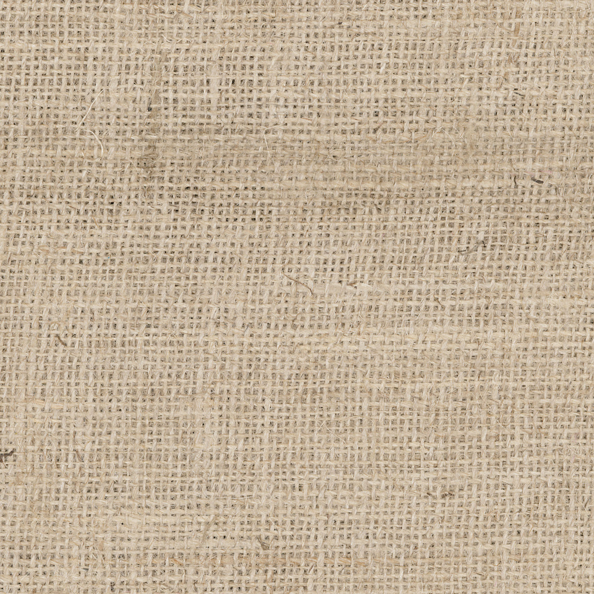A close-up of natural hessian fabric filling the entire frame. The open-weave structure is clearly visible, showing the coarse interlocked fibres in a warm tan and cream tone. The texture is uneven across the surface, with natural variation in the weave throughout.