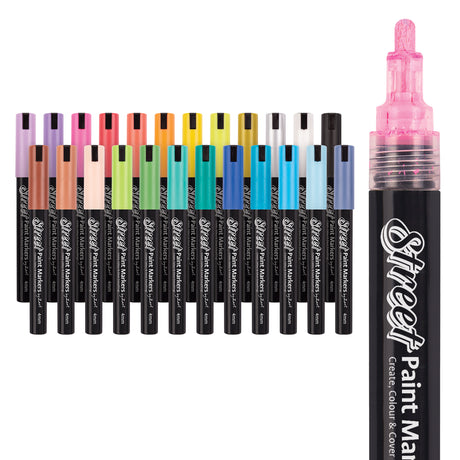 A full set of Street Paint Markers arranged in a rainbow of 24 colours, with one pink marker shown uncapped to reveal the textured 4mm bullet nib.