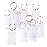 Ten Zart Rectangle Key Ring Tags scattered across a white background. Each tag consists of a clear rectangular plastic frame with a silver metal split ring attached at the top. The inserts are blank and undecorated, showing the transparent plastic casing from various angles.