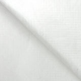 A sheet of white Tyvek material folded diagonally across itself against a white background. The surface shows a subtle woven texture with a faint grid and dotted pattern pressed into it. The lightweight sheet has a soft matte finish, with gentle creasing where it folds.