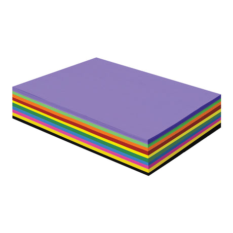 A thick rectangular stack of Zart Prime Copy Paper viewed at an angle, topped with a purple sheet. The exposed edges reveal layered bands of bright colours including green, orange, red, yellow, blue, pink and black, showing the full range within the pack.