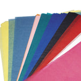 A fan arrangement of translucent Zart Tissue Paper 50x75cm sheets spreads across a pale grey background. The layered tissue paper displays vibrant colours including pink, red, black, blue, teal, peach and yellow, with soft semi-transparent surfaces and delicate overlapping edges creating tonal variation.