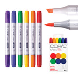 Copic Ciao Marker Set Primary Pack of 6 displayed upright alongside close-up shots of the chisel and brush nibs in use, and the white retail packaging. The six markers in BV08, B29, G07, Y15, YR04, and R37 feature colour-coded caps and barrel ends in purple, blue, green, yellow, orange, and red.