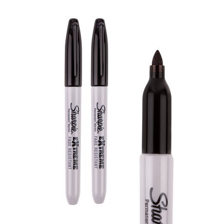 Two capped black Sharpie Extreme permanent markers and one uncapped marker showing the fine point tip, arranged on a white background.