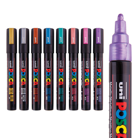 POSCA Metallic Marker set of eight shown with lids on in a row, each cap coloured to match its ink: gold, silver, bronze, blue, green, red, pink and violet. A larger uncapped violet marker sits beside them, showing its rounded metallic nib and black barrel with coloured text.