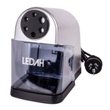 The Ledah Electric Pencil Sharpener is shown against a pale background with a silver and black body, clear removable shavings tray and attached Australian power plug. The front features six sharpening size holes, while the compact desktop design suits classrooms, studios and office environments.