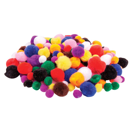 A large loose pile of Zart Basics Assorted Pom Poms in three sizes, spread across a white surface. The mix includes fluffy pom poms in red, blue, yellow, orange, green, purple, pink, white, brown, and black, with size variation clearly visible throughout the pile.