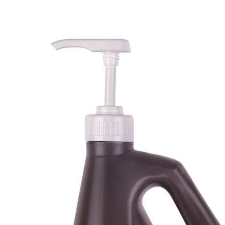 Zart School Colours Paint Pump fitted to a dark brown 2 litre bottle, shown close-up. The white pump head has a curved lever spout above a ribbed collar, with a clear plastic tube extending down into the bottle through the screw-fit neck.