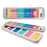 Product image of Creamy Colours Watercolours by Zart Macaron, showing a silver metal tin closed and partially open to reveal six watercolour pans. Packaging displays the product name, brand and “6 Colour Palette”. Colours include caramel brown, grape purple, mint green, berry pink, peach and blue.