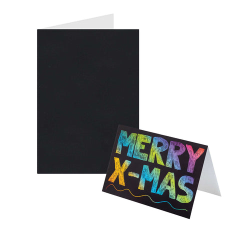 A plain black Zart Scratch Greeting Card shown open and blank, displaying its black-coated surface and white interior, next to a finished sample card scratched with "MERRY X-MAS" in rainbow lettering and a wavy line beneath, demonstrating the colour revealed by scratching.