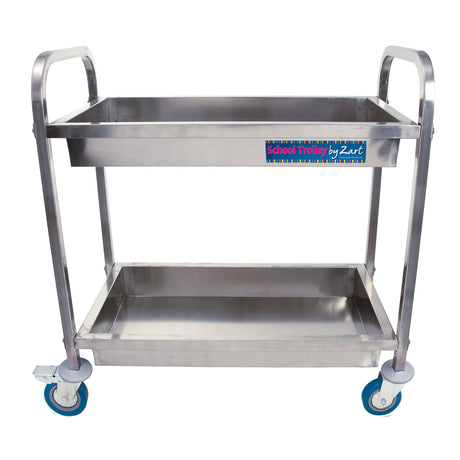 Stainless steel two-tier school trolley on four castors with handles at each end. Front panel shows brand label “School Trolley by Zart”. Clean, empty trays shown against a white background.