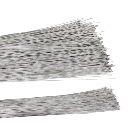 Two bundles of straight silver florist wire laid horizontally against a white background, the fine metallic strands fanning out at the cut ends. The long, slender wires have a bright silvery-grey finish and lie in loose overlapping layers, a few crossing diagonally across the stacks.