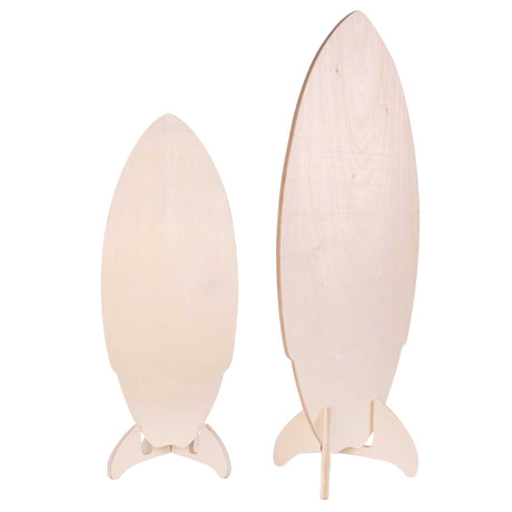 Two unpainted surfboard-shaped plywood blanks displayed upright side by side on wooden stands against a white background. The smooth, pale timber surfaces and difference in viewing angle are clearly visible.