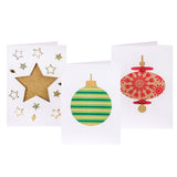 Three decorated samples made using Zart Cards and Envelopes Xmas Cut-Outs cards. A gold glitter star surrounded by scattered star and diamond sequins, a green-and-gold striped round bauble, and a red snowflake-patterned finial bauble on kraft paper show through each die-cut window.