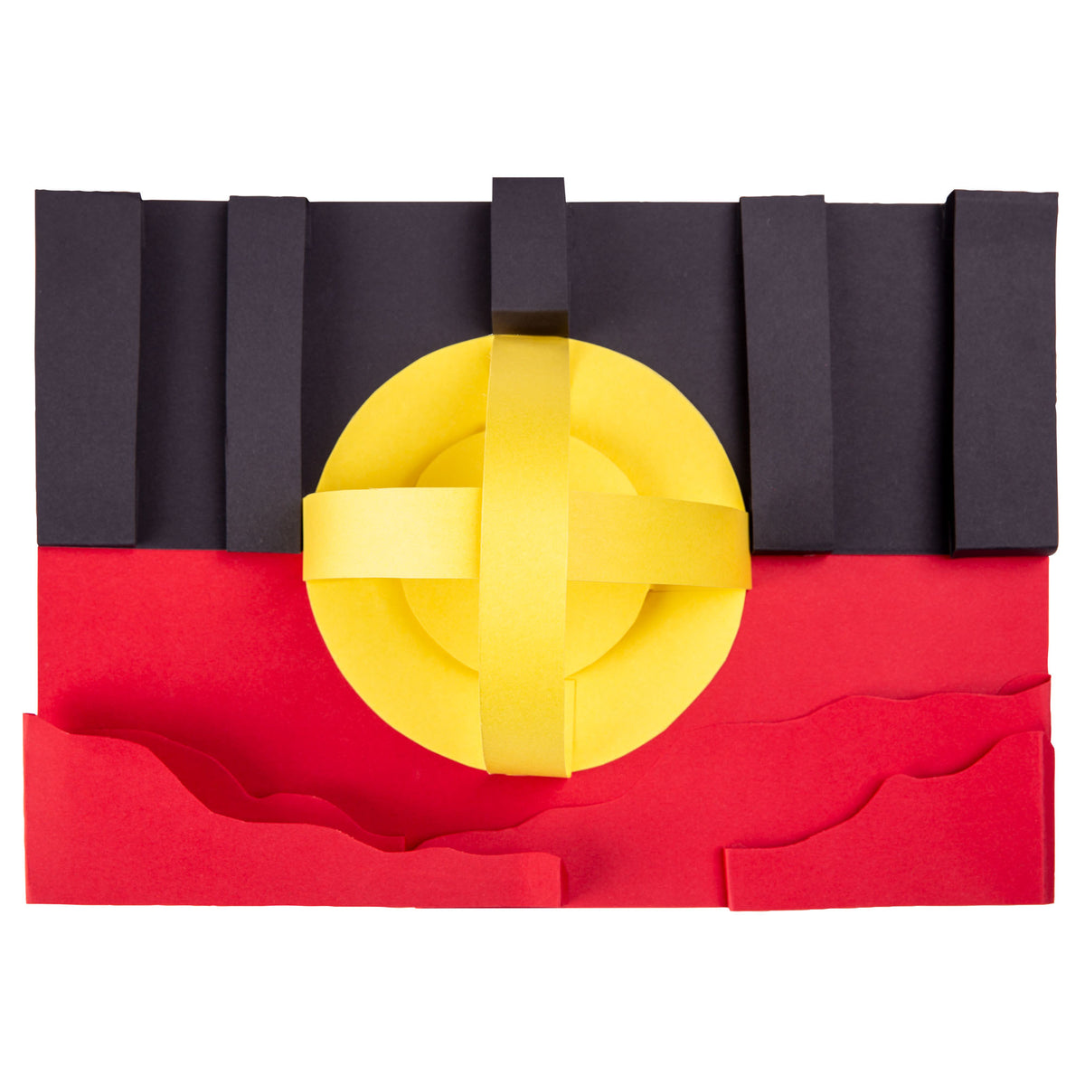 The Aboriginal Flag recreated in Zart coloured card from the Australian Flag Colours pack. Upright black strips form the top half, a flat red base sits below with wavy raised edges, and a yellow circular sun shape with crossed bands sits centred across the join between the two colours.