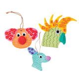 Three decorated hangers made using Zart Wooden Australian Animal Hangers, transformed into colourful creatures with textured clay ears, snouts and crests in orange, pink, green, yellow and teal. Joggle Eyes and jute string loops complete each playful design.