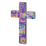 Decorated wooden cross featuring mosaic tiles arranged across a purple background. Irregular shapes in blue, pink, yellow and gold create patterns and borders. Grout lines define sections, highlighting texture. Rounded edges remain visible, demonstrating how the blank can be transformed into a colourful finished artwork.