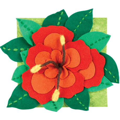 A layered felt flower made from Zart felt, with red and orange petals arranged in overlapping rounded layers over a pale green felt square. Dark green pointed leaves surround the bloom, each stitched with a dashed line of thread. Pale yellow-tipped brown cord curls from the flower's centre.