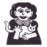 A sample artwork printed using Derivan Block Ink. A bold black and white relief print depicts a figure with curly hair holding a small cat, wearing a striped collar. The image shows strong contrast with expressive, graphic mark-making typical of block printing technique.