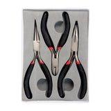 The Zart Jewellery Plier Set of three presented in a grey moulded tray inside a clear plastic case. All three pairs have black foam grips with red bands, arranged with jaws upward — round nose, flat nose and a central pair of diagonal cutters.