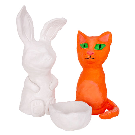 Three models made from white air drying clay, shown together against a white background. A tall unpainted rabbit sits upright with long ears, a small white rounded bowl sits in front, and a cat painted bright orange with green eyes and a pink nose sits to the right.