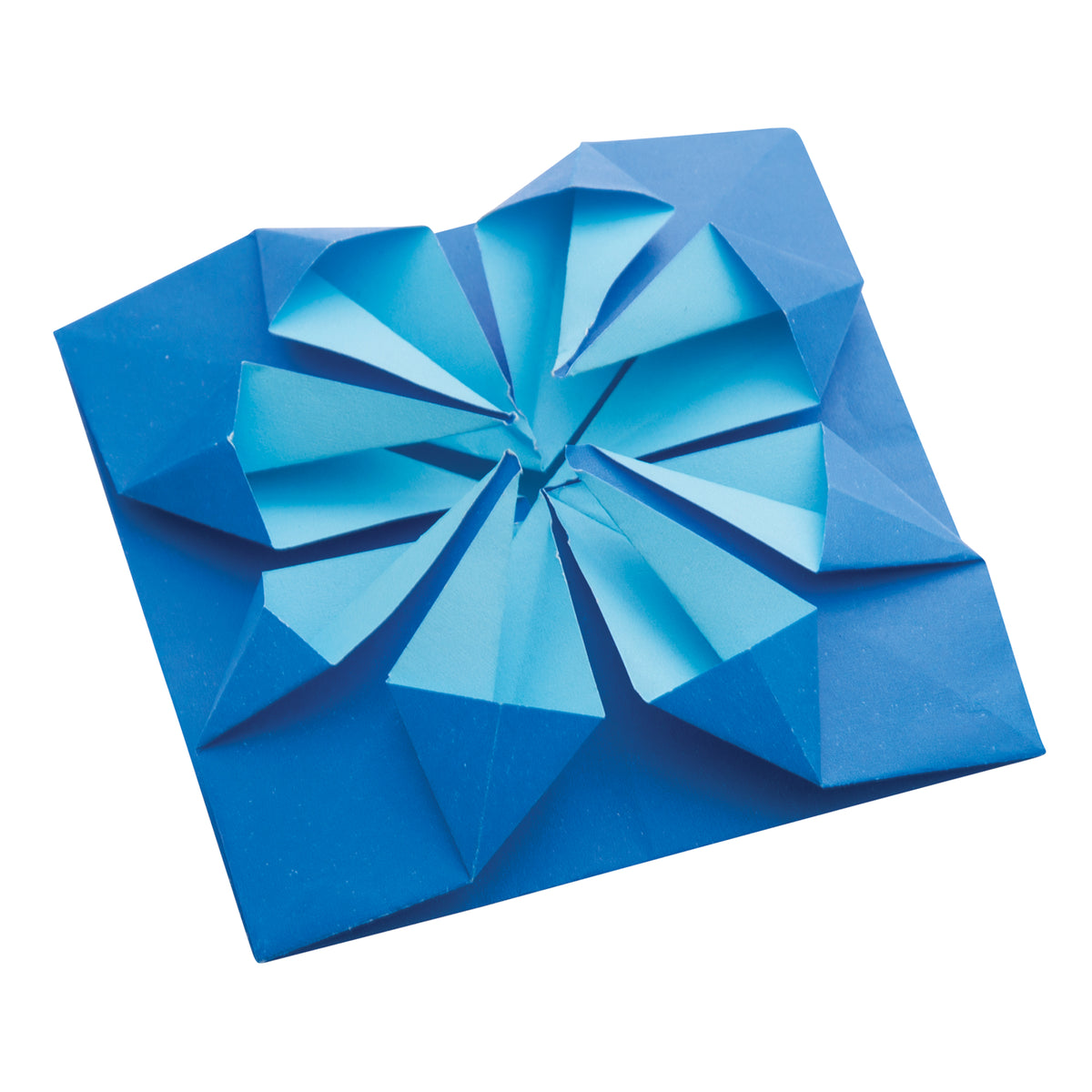 A square of folded Collagami paper in two tones of blue, with the lighter blue reverse showing through. Narrow triangular pleats radiate from the centre in two spiral-like clusters, creating a raised, geometric three-dimensional form set against a plain white background.